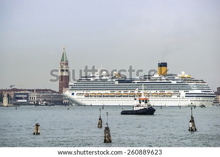 Tug boat and cruise liner in front of Doges palace Campanile of St. Marco, St. Marco lion statue in summer Venice