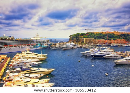 MONTE CARLO, MONACO - AUGUST 9, 2010: Port Hercule harbor marina, luxury ships, cruise liner and yachts and Palace of Prince of Monaco on the mountain in the Monaco (Monte Carlo) in summer