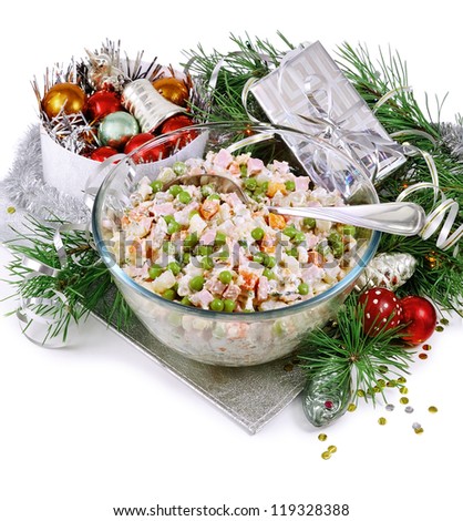 New Year\'s still-life with a Russian salad and Christmas toys on silver napkin.