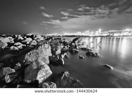 Stones and ocean at night in black and white