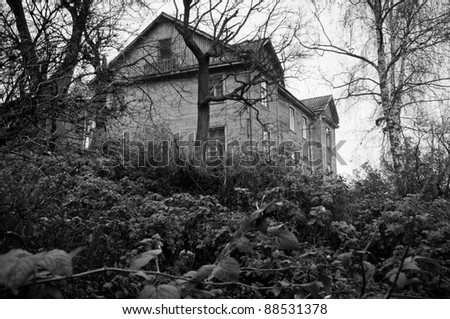 Lonely, dark abandoned house on the hill, black and white