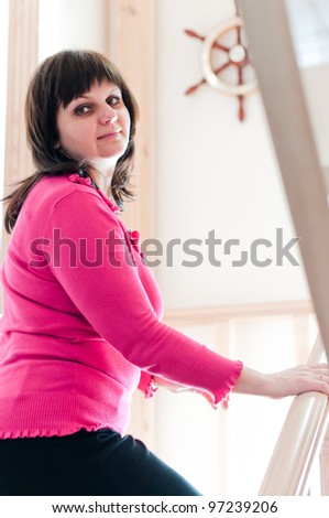 Beautiful adult woman turning and smiling expressing positivity