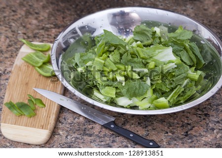 Different salad ingredients  on a plate waiting to be used.