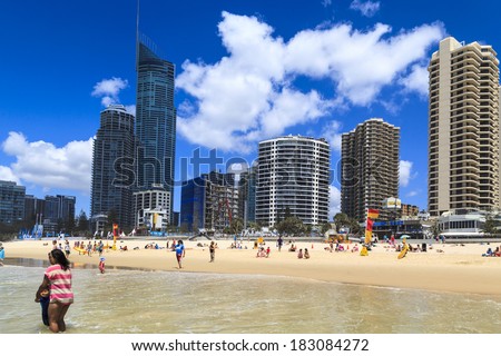 SURFERS PARADISE-OCT. 19: Holiday-makers take an early morning stroll on the beach at Surfers Paradise one of the best holiday spot on Earth, Queensland, Australia on 19 October 2013.