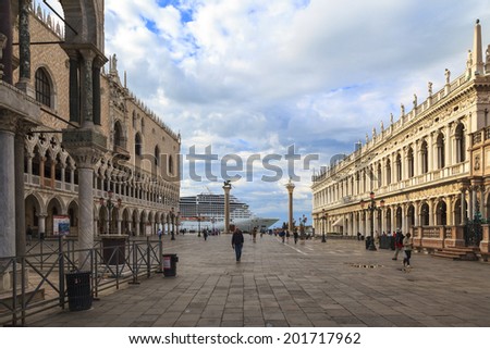 VENICE, ITALY - JUN 9: Tourists enjoy sightseeing in St. Mark\'s Square in the morning while a cruse liner just arrive on Jun 9, 2014 in Venice, Italy. St. Mark\'s Basilica is nearly 1000 years old