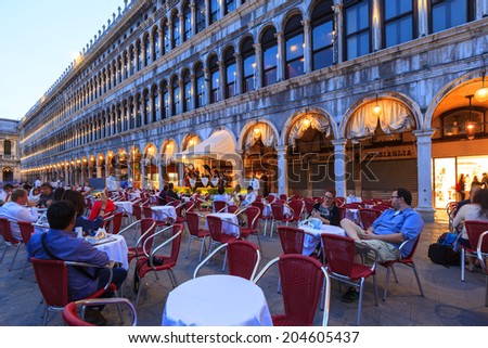 VENICE - JUN 2:People in the restaurant in St Mark\'s Square, Venice Italy. Each year the city receives 20 million tourists. This equates to approximately 60,000 visitors each day  2014 Italy