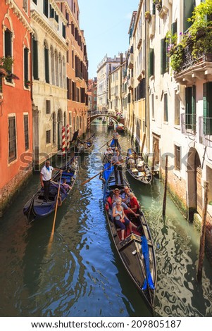 VENICE, ITALY-01 JUNE, 2014: Gondolier rides gondola with tourists. The profession of gondolier is controlled by a guild, which issues a limited number of licenses also one of the best know transport