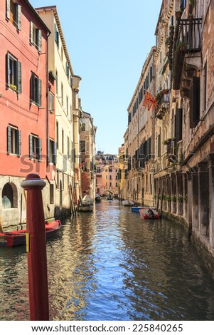 Venice canal with houses and bridge on the street