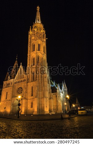 BUDAPEST MAY 9 2014: Newly renovated Mathias Church in Budapest is a big attraction for tourists all over the world. Budapest's beauty shown at night through many centuries of architecture, Hungary.