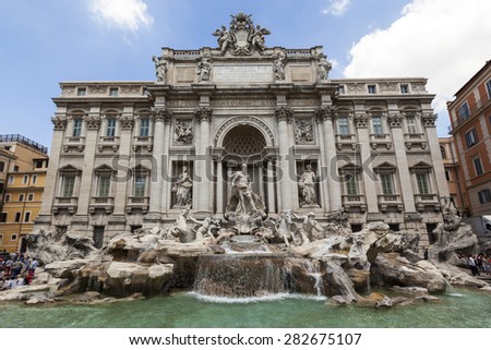ROME, ITALY - MAY 21, 2014: Tourists visiting the Trevi Fountain. Trevi Fountain is an iconic symbol of Imperial Rome. It is one of Rome's most popular tourist attractions.
