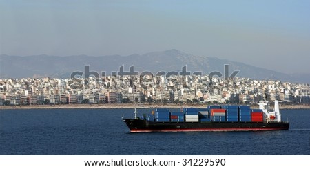 Cargo ship sailing with sea containers on deck