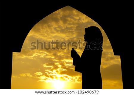 Silhouette of Female Muslim praying in mosque during sunset time