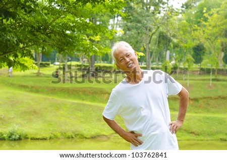 Retired Asian senior man exercising in park