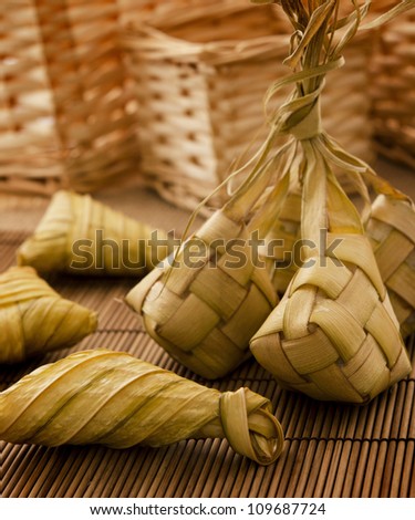 Asian cuisine ketupat or packed rice in low light setting.