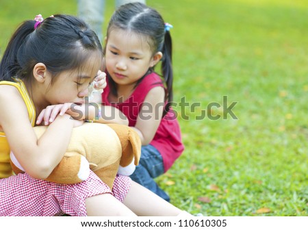 Little girl is comforting her crying sister