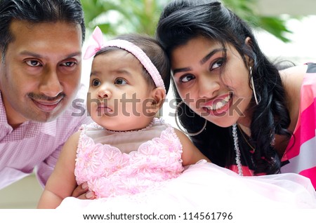 Indian parents and baby girl at outdoor home garden