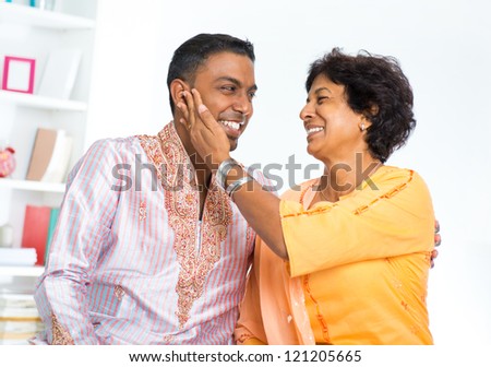 Happy mature Indian woman with her adult son