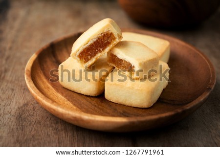 Pineapple cake is a sweet traditional Taiwanese pastry containing butter, flour, egg, sugar, and pineapple jam.