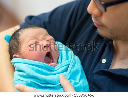 Asian father and newborn baby girl in hospital Asian father and newborn baby girl in hospital