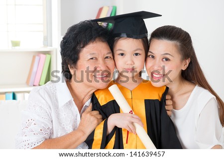 Kindergarten graduation. Happy Asian family, grandparent, parent and grandchild on her kindergarten graduate day.
