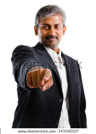 Good looking mature Asian Indian business man with business suit finger pointing at you, focus on finger, isolated on white background. Portrait of handsome Indian male model.