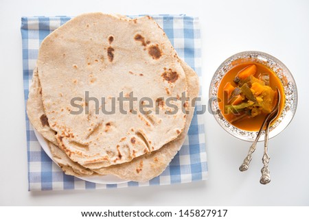 Chapatti roti or Flat bread and curry dahl. Indian food on dining table.