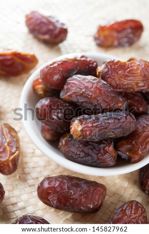 Dried date palm fruits or kurma, ramadan food which eaten in fasting month. Pile of fresh dried date fruits in a plate.