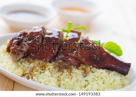 Peking duck or Roasted duck, Chinese style, served with steamed rice on dining table. Hong Kong cuisine.