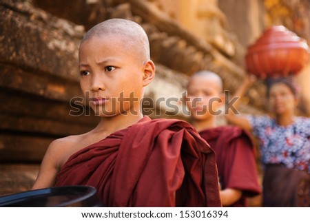 Southeast Asian Young Buddhist Monks Walking Morning Alms In Old Bagan, Myanmar