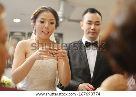 Traditional Chinese wedding, bride and groom serving tea to elders.