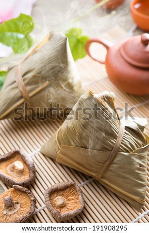 Traditional steamed sticky glutinous rice dumplings. Hot rice dumpling or zongzi. Chinese festive food. Asian cuisine.