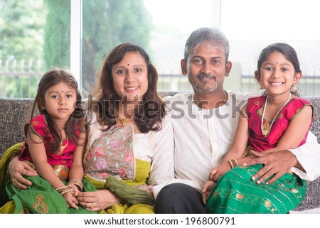 Happy Indian family at home. Asian parents and children living lifestyle, sitting on couch indoor happily.