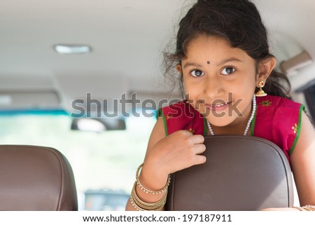 Happy Indian girl in car, smiling happy ready going to family vacation.