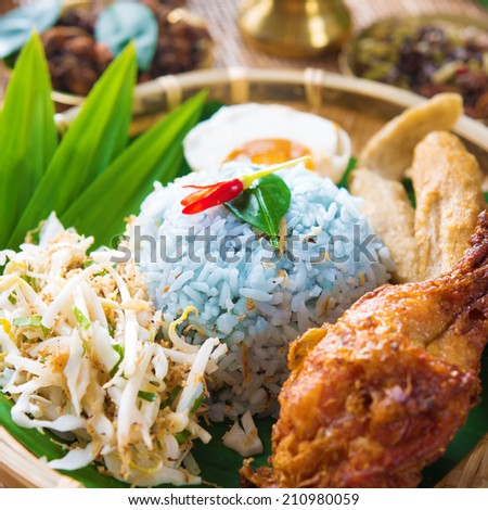 Nasi kerabu or nasi ulam, popular Malay rice dish. Blue color of rice resulting from the petals of butterfly-pea flowers. Traditional Malaysian food, Asian cuisine.