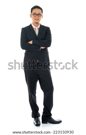 Full length pan Asian business man crossed arms standing isolated on white background.