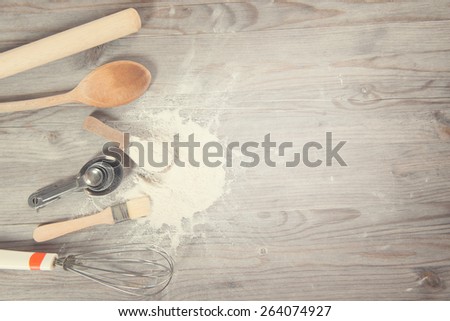 Baking utensils from top view on wooden table in vintage tone, copy space on side.