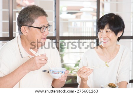 Senior Couple Eating Meal At Home. Asian family living lifestyle.