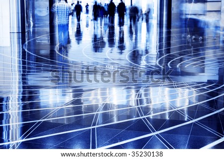 People walking thru the mall. A shopping mall. Long exposure for intentional motion blur of people.