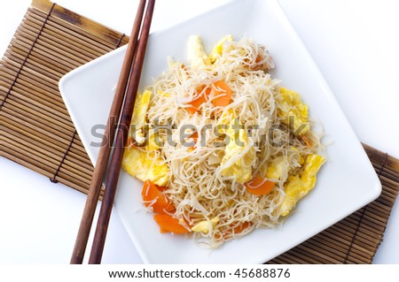 Fried rice vermicelli. Asian fried rice vermicelli with eggs and carrot. Serve with chopsticks.