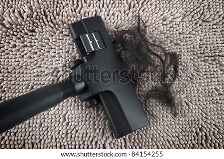 Vacuum cleaning fall hair on carpet