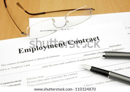 employment contract form with glasses and pen