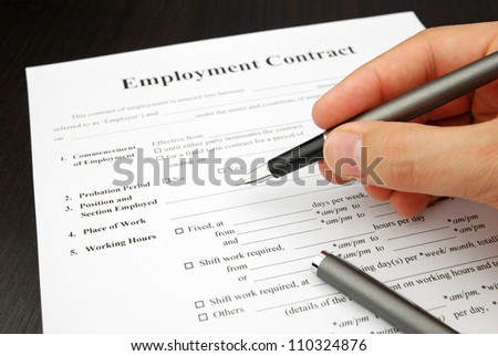 employment contract form with human hand pen signing