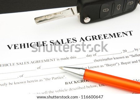 Vehicle Sales Agreement Document Form with orange Pen and Car Key