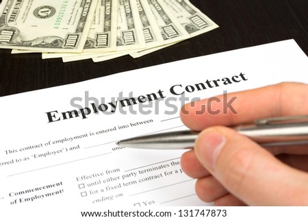 employment contract with dollar, hand and pen for signature