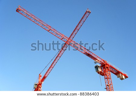 Red Cranes crossing at a construction site