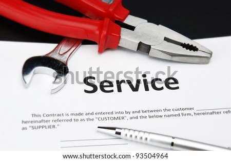 service contract agreement with pen, wrench and nipper
