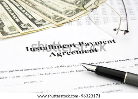 installment payment agreement document with glasses and filler