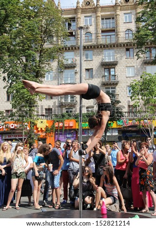 KIEV, UKRAINE - JUNE 30: Unidentified  pole dancer woman and spectators during Youth Day  in Kiev, Ukraine on June 30, 2013