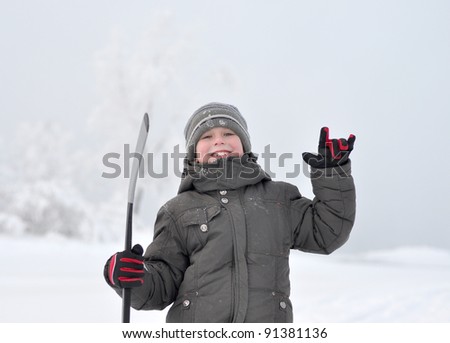 Portrait of  smile boy with an ice hockey stick on  nature