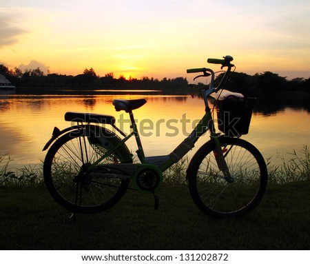 bike silhouette in the river at sunset
